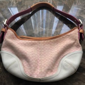 Light pink and white small coach purse.